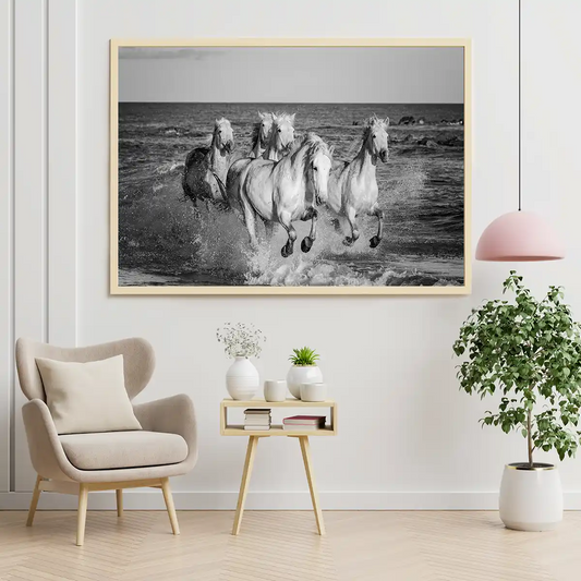 Herd of White Camargue Horses Running Along Water in Black and White