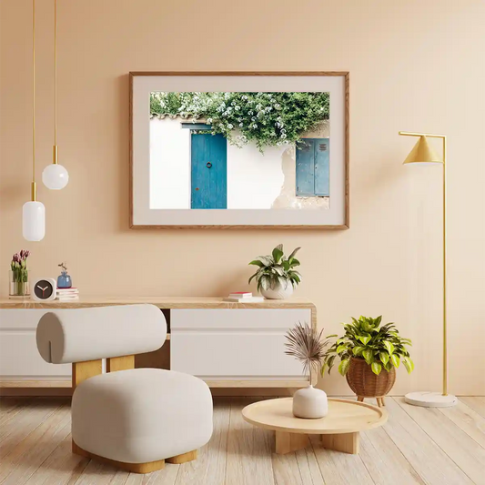Traditional Greek House Facade with Blue Door and White Flowers in a Sunny Day