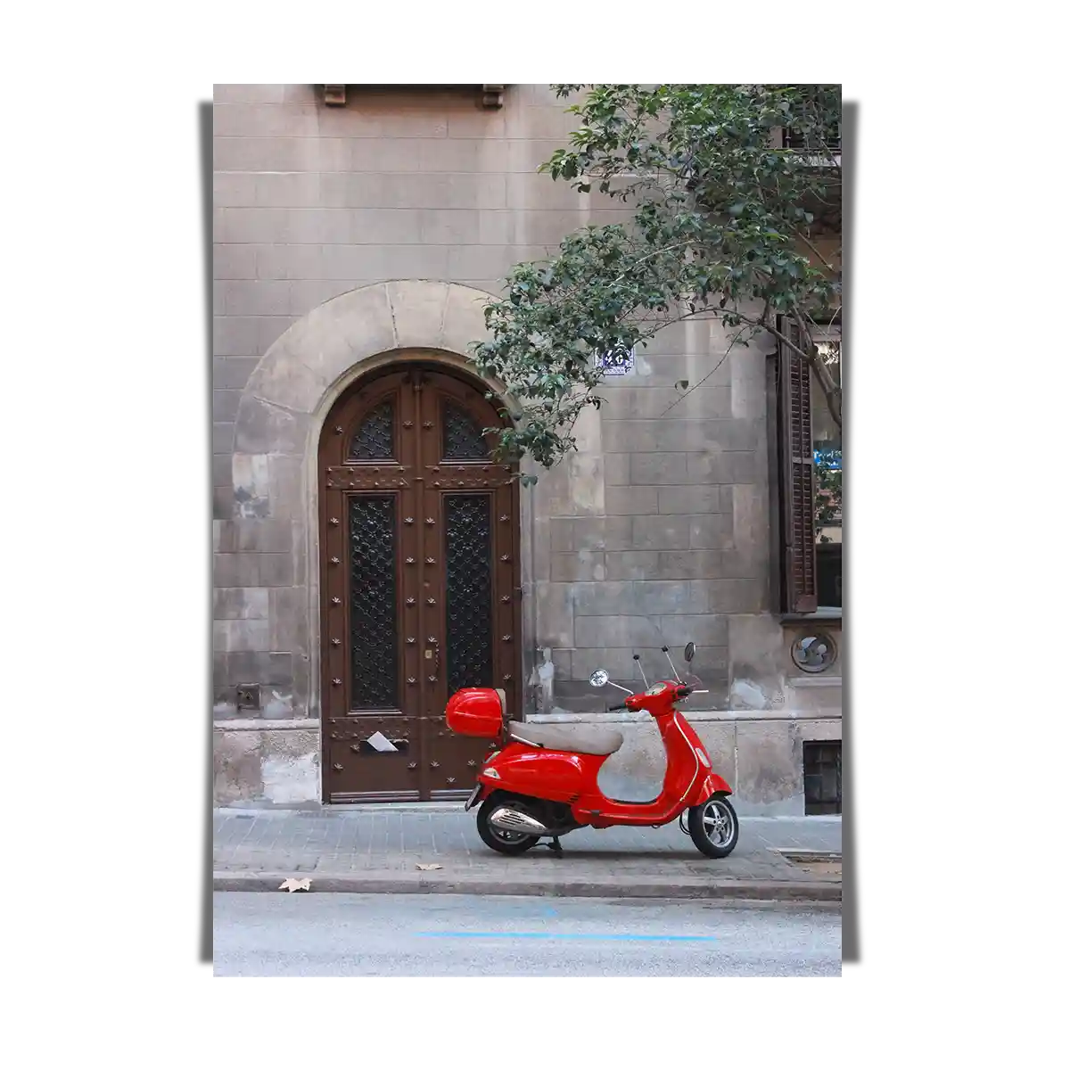 Red Vespa Scooter Parked in a Side Street of a Heritage Building in Europe