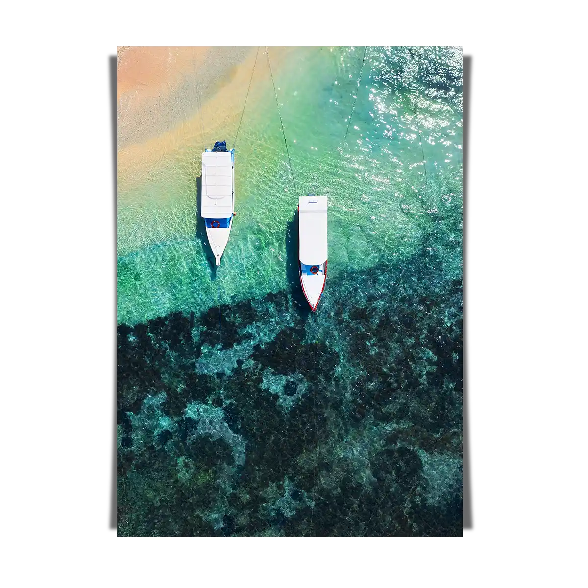 Boats on clear water beach from top view