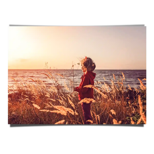 Girl Overlooking at Sunset by the Bay with Grass Field