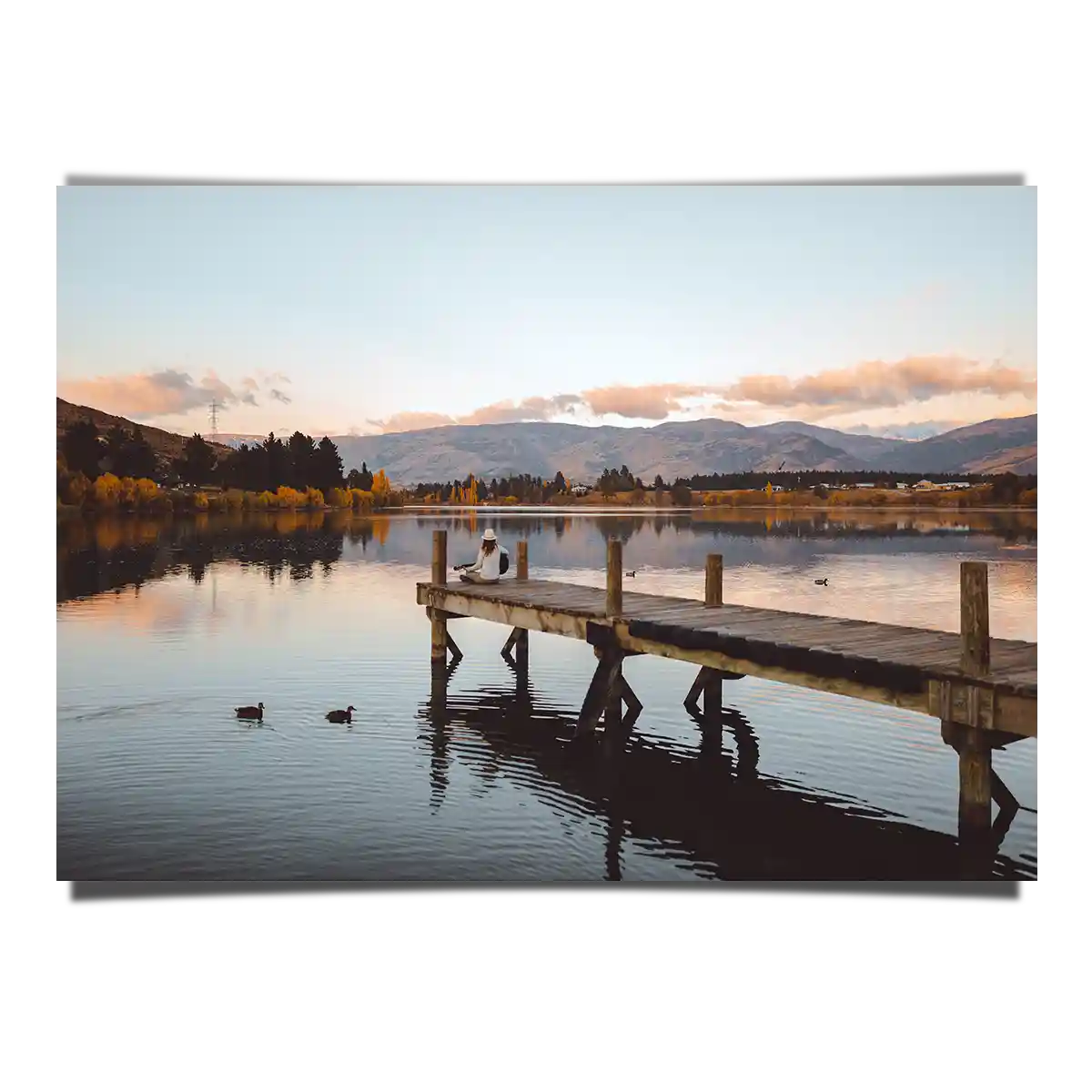 Lake Pier with Ducks and Woman Sitting with Guitar in Cromwell New Zealand
