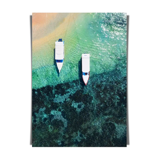 Boats on clear water beach from top view