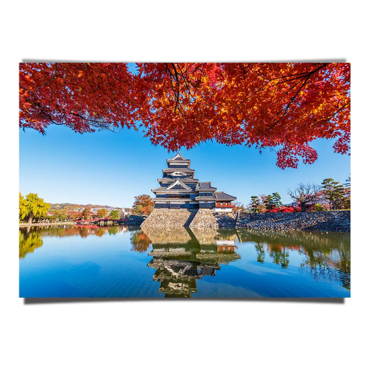 Matsumoto Castle with Maple Leaves at Autumn Reflecting on Water in Nagano Japan