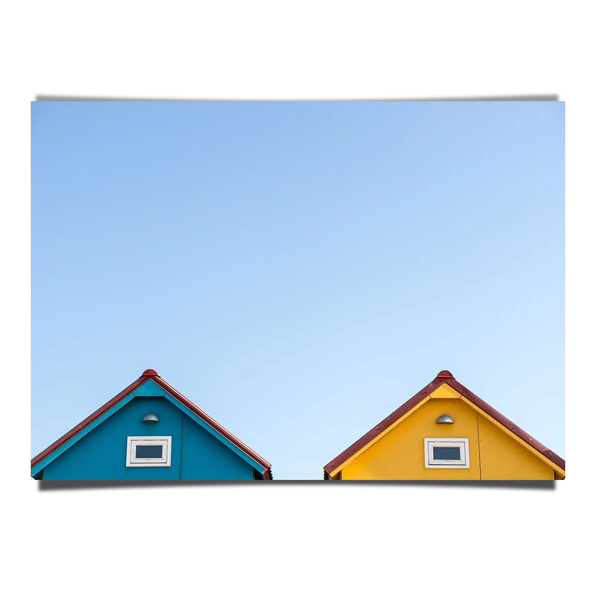 Peeping Beach House Rooftops Over Clear Blue Skies